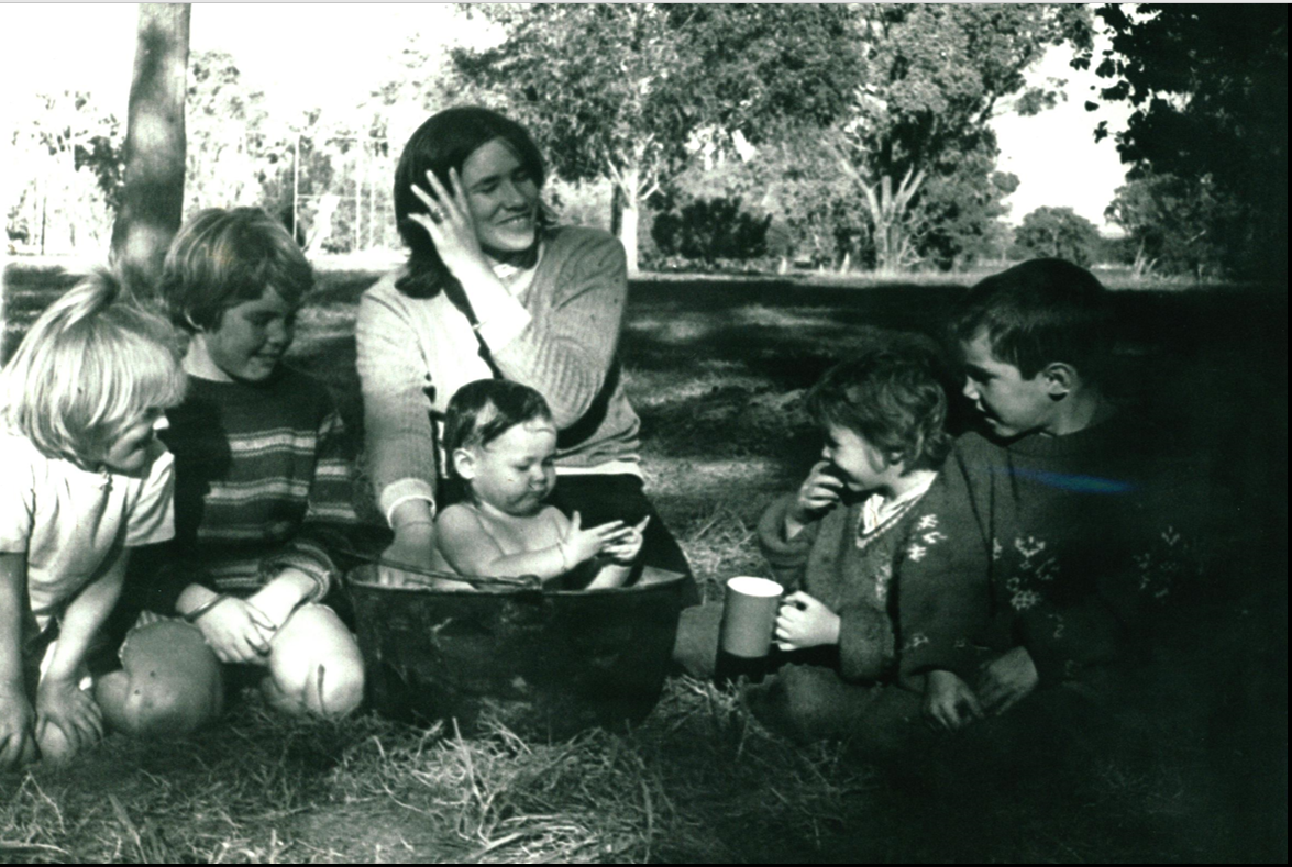 A photo of children enjoying a play group in the park, organised at the Family Centre.
