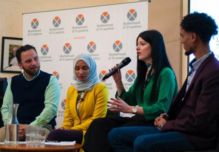 Four people speaking on a panel