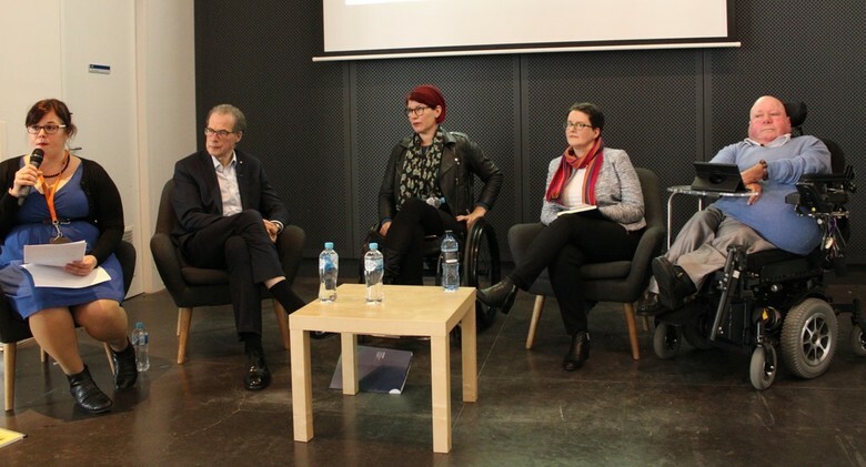 Five people participating in a panel