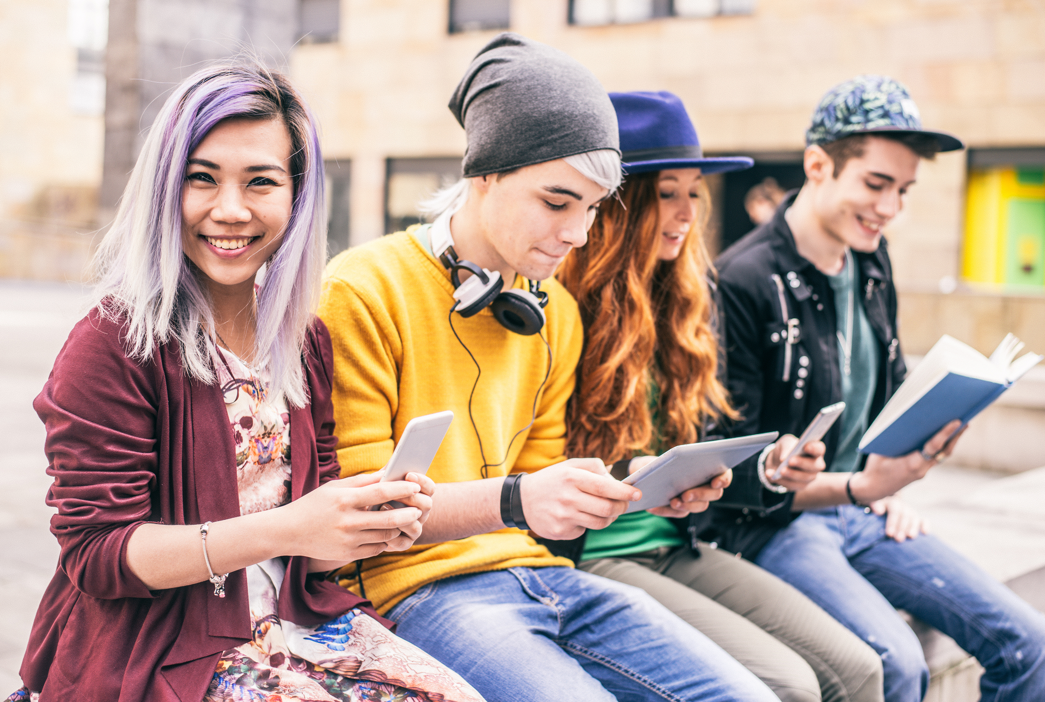 A group of young people sitting on a bench