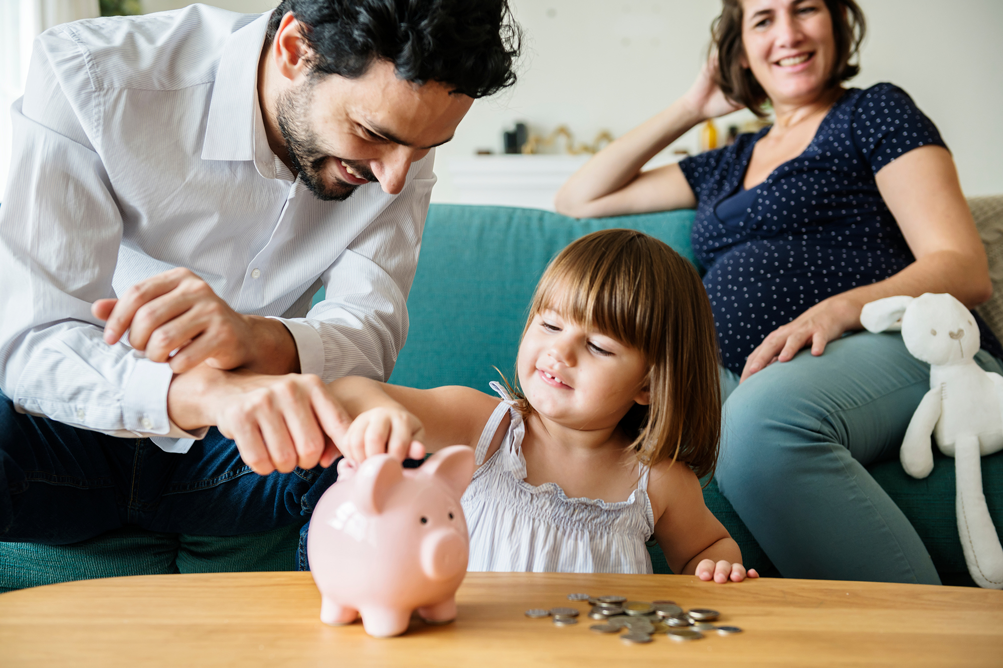 A young family gathered around a family table discussing their finances.