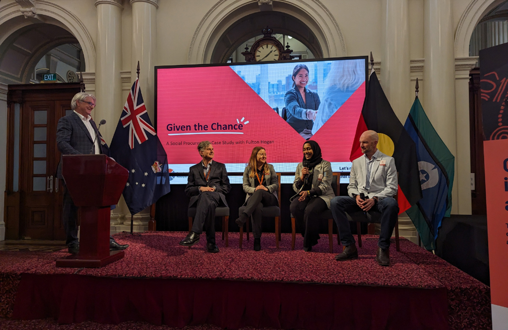 The Social Procurement panel (left to right) BSL’s Peter Flugge, Simon Gray and Marina Goshevska, and Hind Osman and Mathew Inkster from Fulton Hogan. There is a screen with Given the Chance branding on it and on either side of it are the Australia and First Nations flags