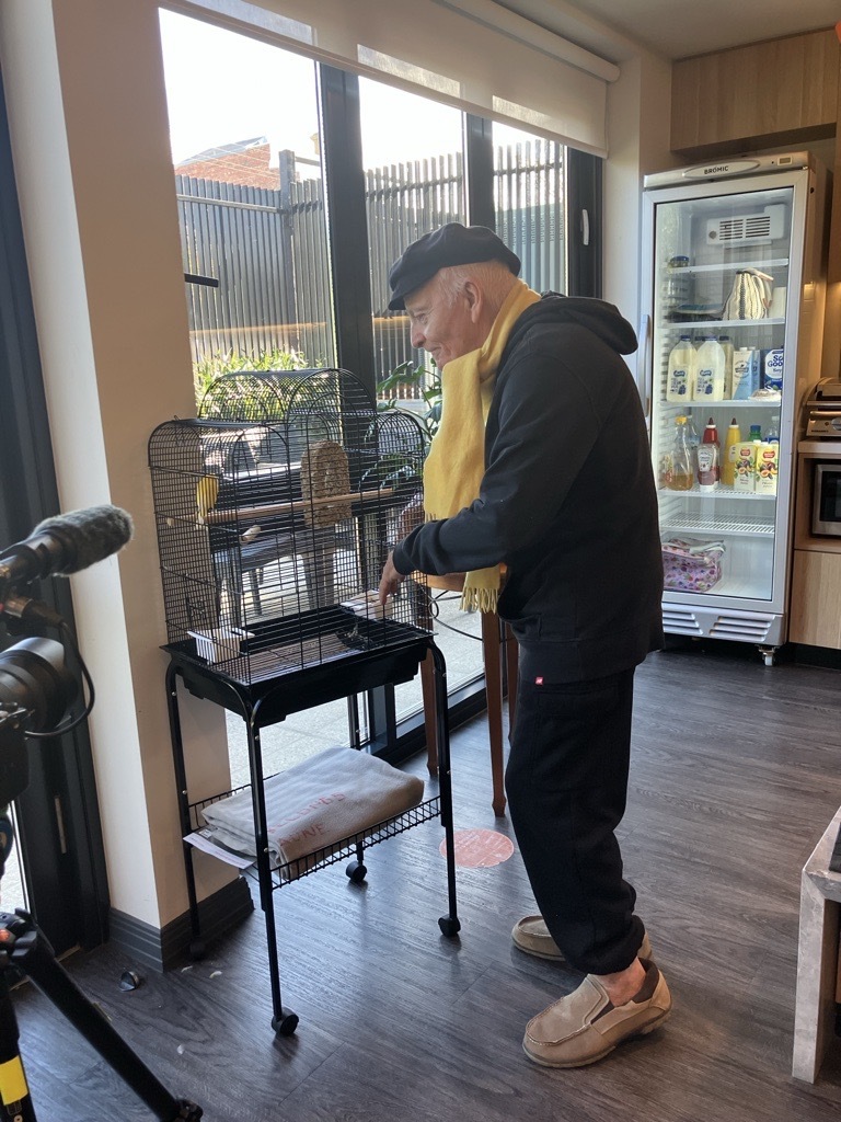 Paddy on his morning round of greetings at Clifton Hill Aged Care starting with ‘Jaune’ his beloved pet bird.