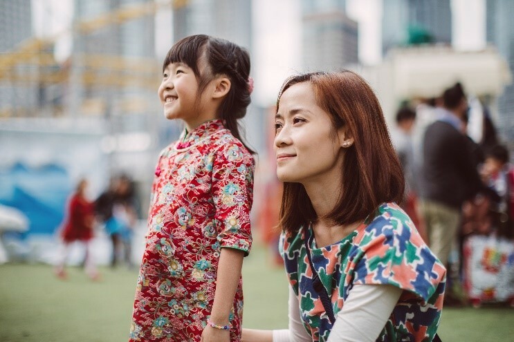 A mother and daughter sitting in a park