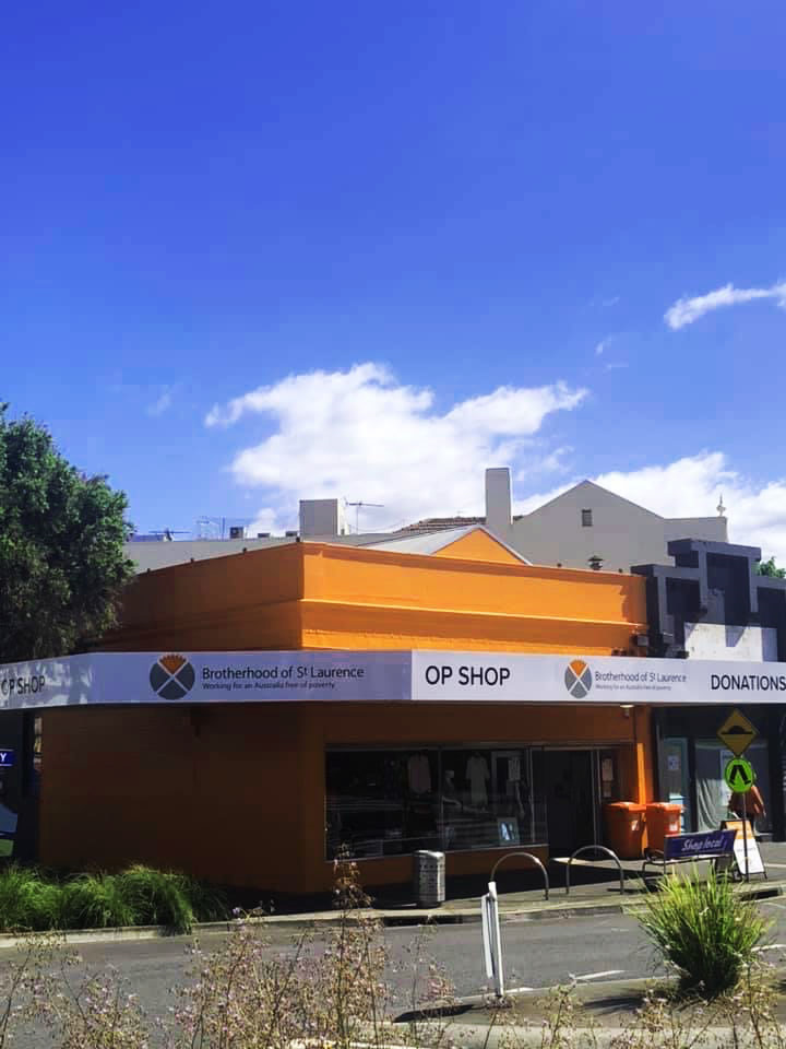 An orange building on a suburban street corner with the BSL logo on it saying Op Shop