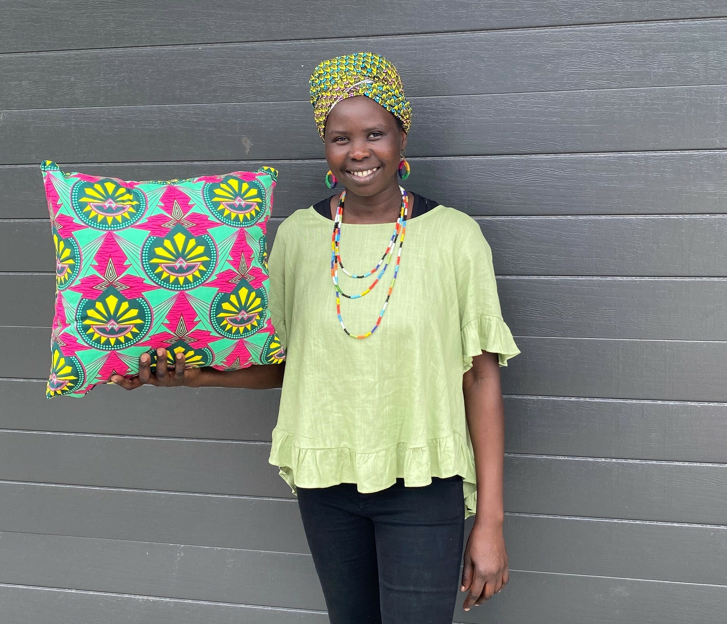 A black woman holding a throw pillow