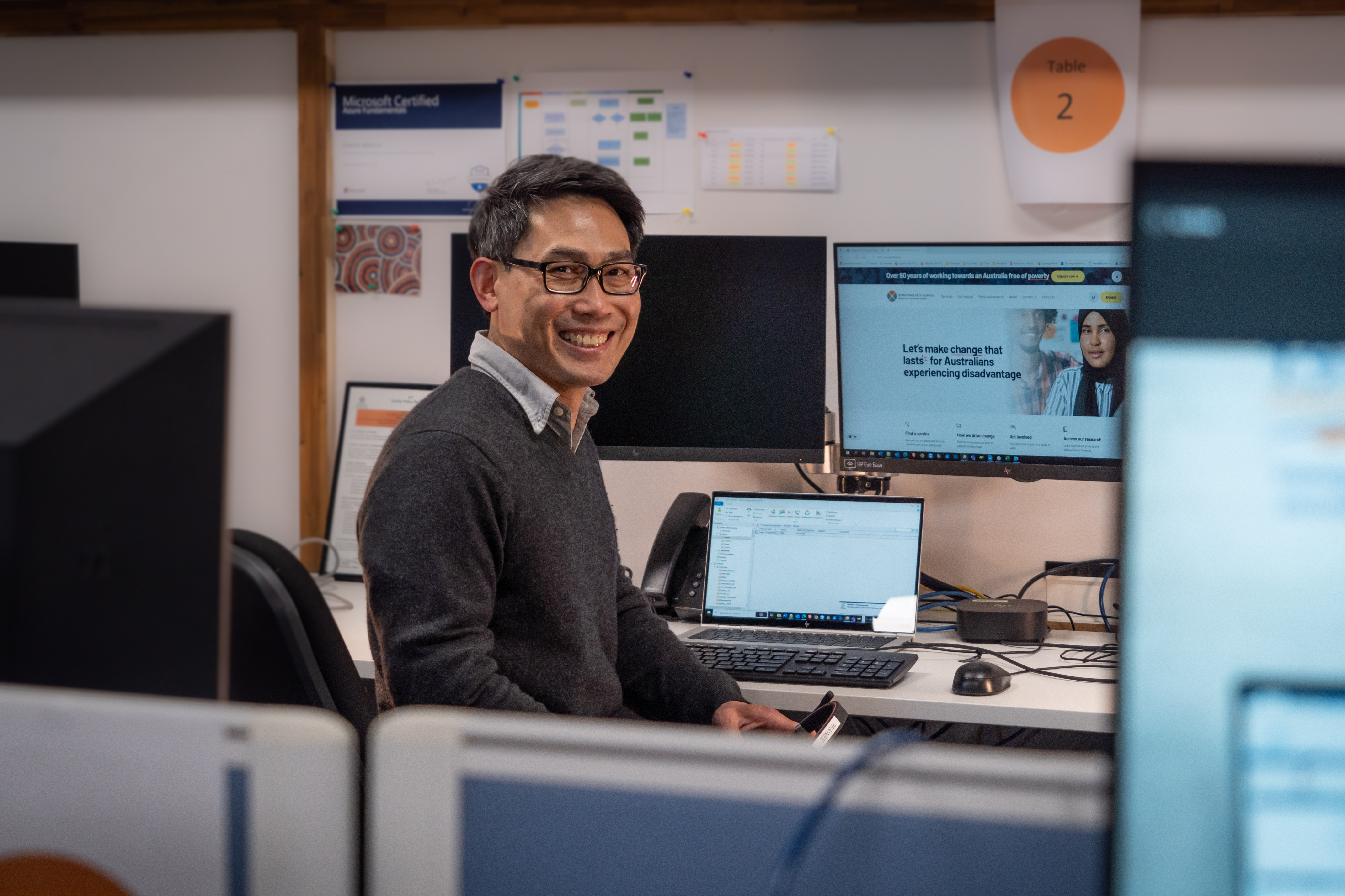 BSL volunteer Prawee, sitting at a desk with a computer