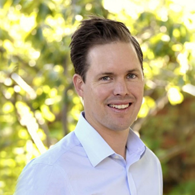 A young smiling man in business atire