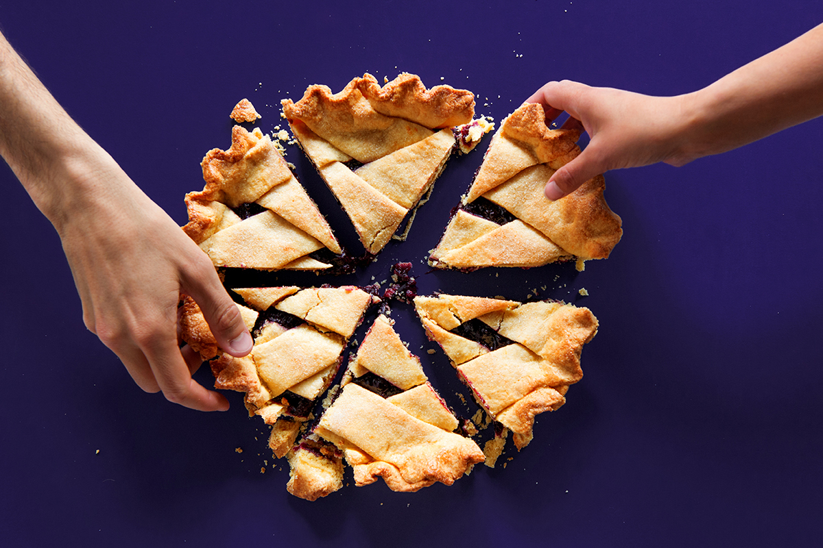 Hands reaching for pie