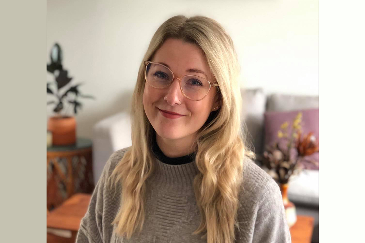 A woman smiles at the camera