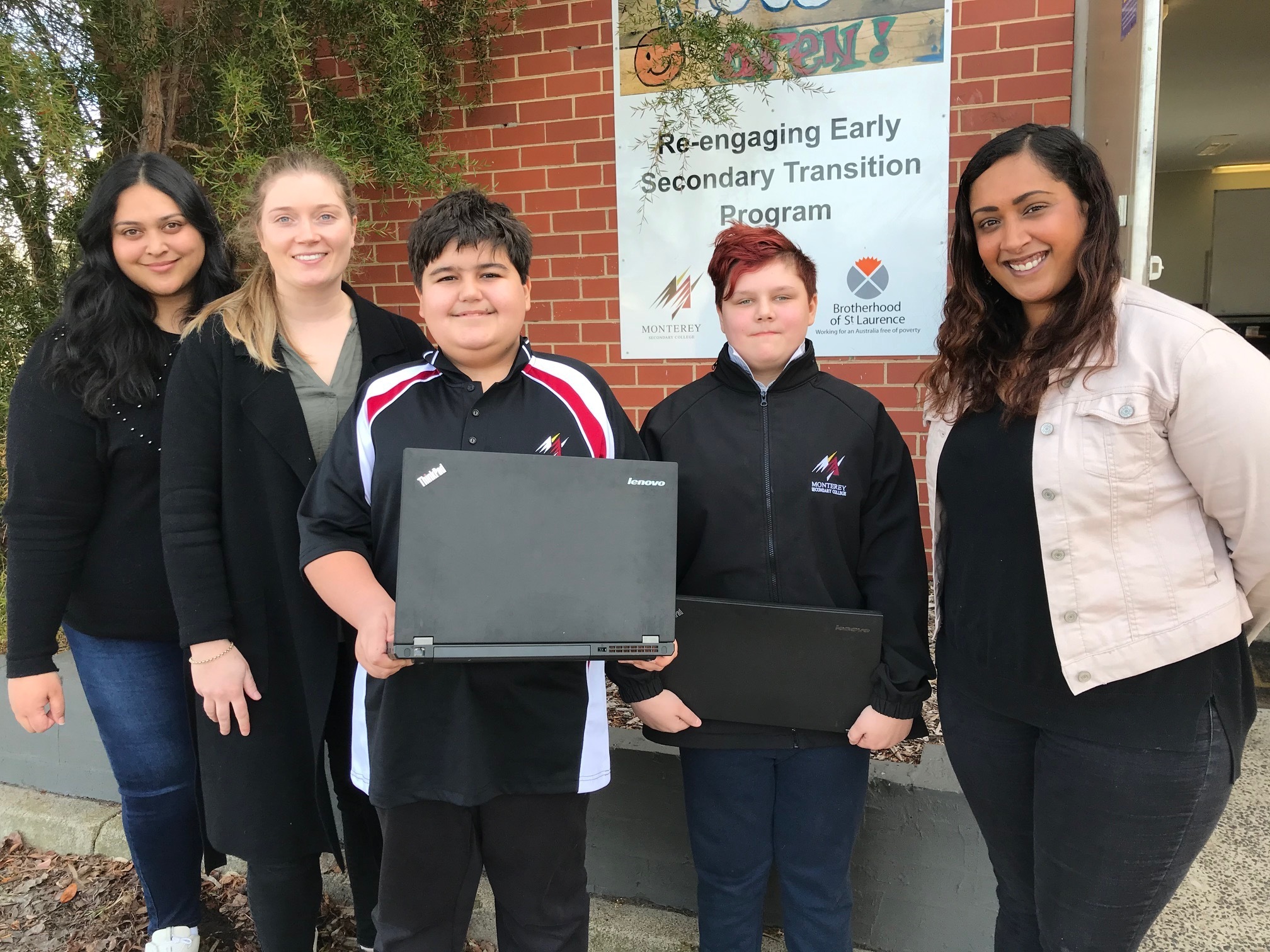 A group of school students holding laptops