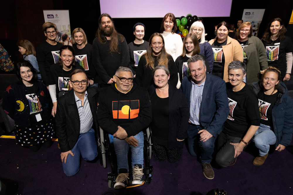 A group of people pose for the camera inside a cinema