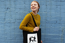 Staff member models Anti Poverty Week tote