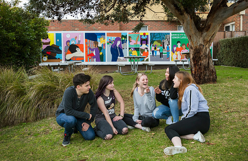 David Scott School students chatting on lawn