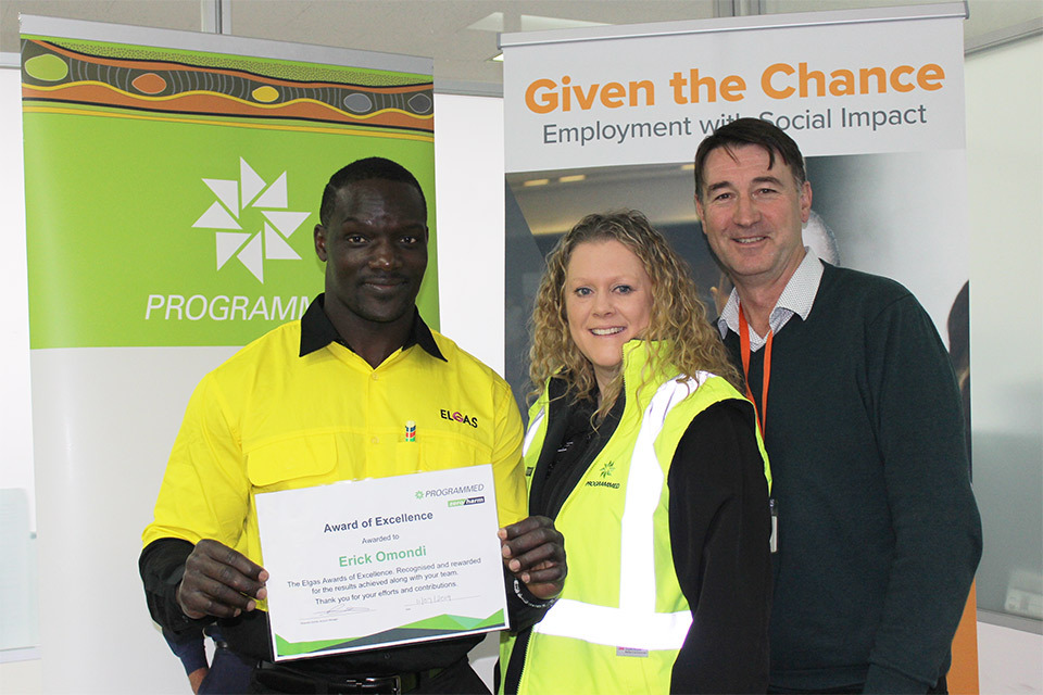 Elgas with his Programmed award and two Given the Chance team members