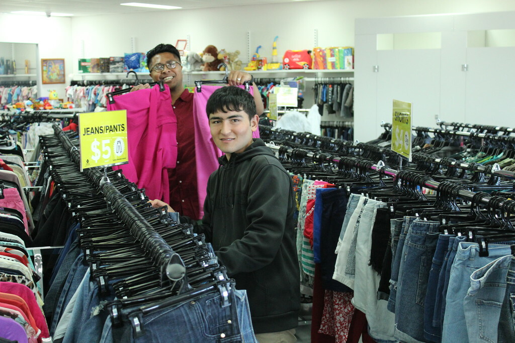 Two volunteers working in a BSL op shop