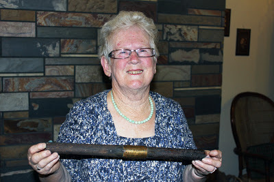 Elizabeth holds war memento up