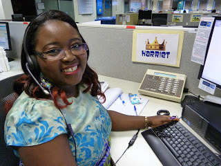 Harriet at her desk, smiling