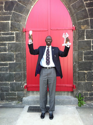 Abraham Mamer holds up his prizes