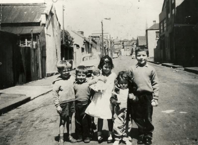 Children pose in the street of the Fitzroy slums