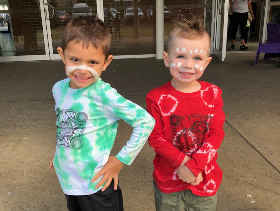 Five-year-old HIPPY Goonellabah children model freshly tie-dyed and screen-printed tees, made during a 2019 Reconciliation Week event. Goonellabah is an Aboriginal family-focussed site in NSW.