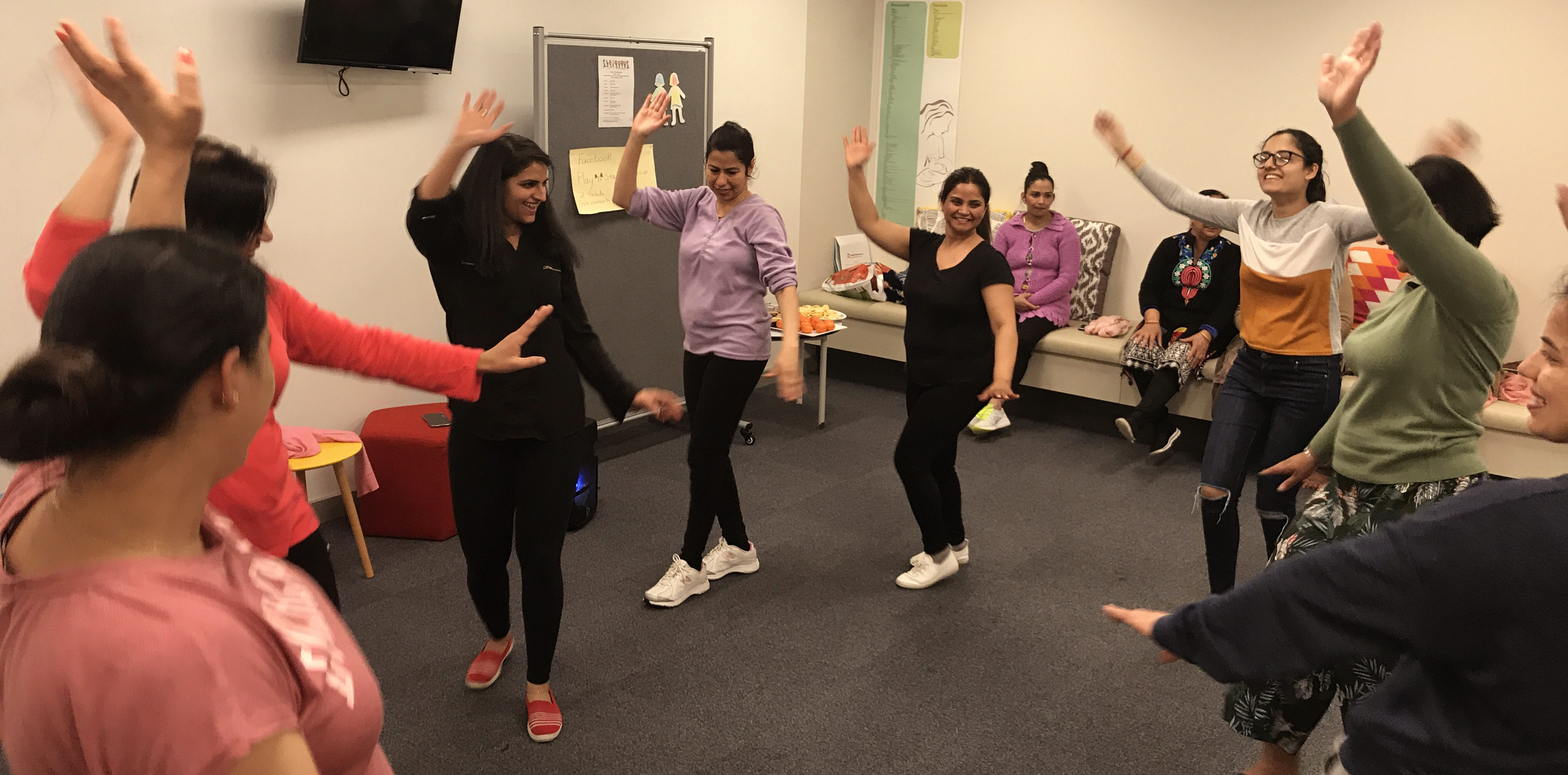 Women dance in a classroom.