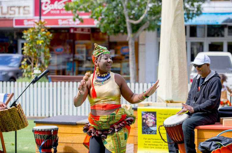 Florence dancing to man playing djembe drum