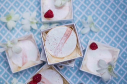 Cakes in boxes with flowers around them